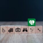 Wooden toy blocks stacked with medical icon for medical and health insurance concepts.